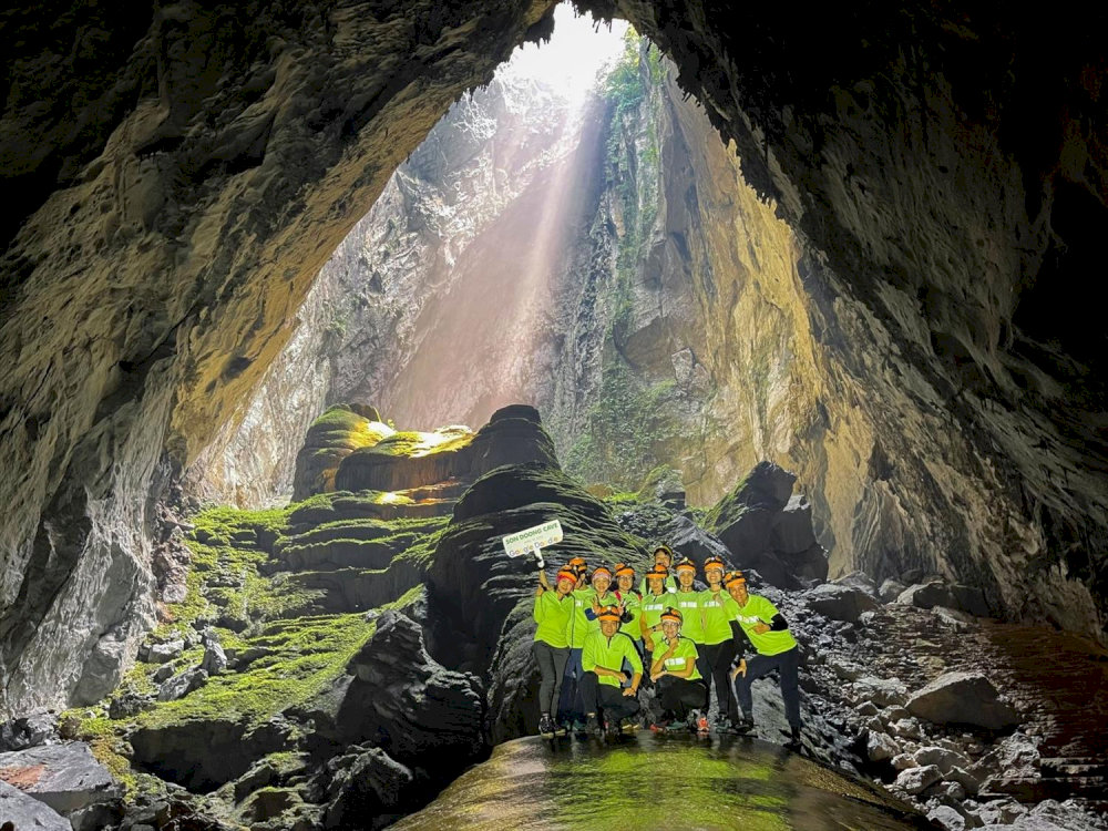 Participants are equipped with safety gear, including helmets, harnesses, and headlamps